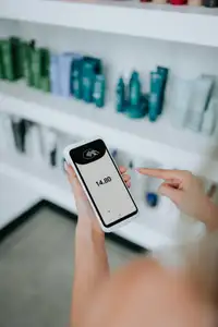Persona che effettua un pagamento contactless con carta su un lettore POS